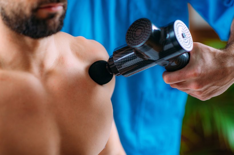 Massage Gun Physical Therapy Therapist Treating Patient’s Chest with Massage Gun